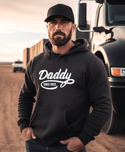 man wearing a custom printed designs plus custom hoodie with the words daddy Est. 2024
